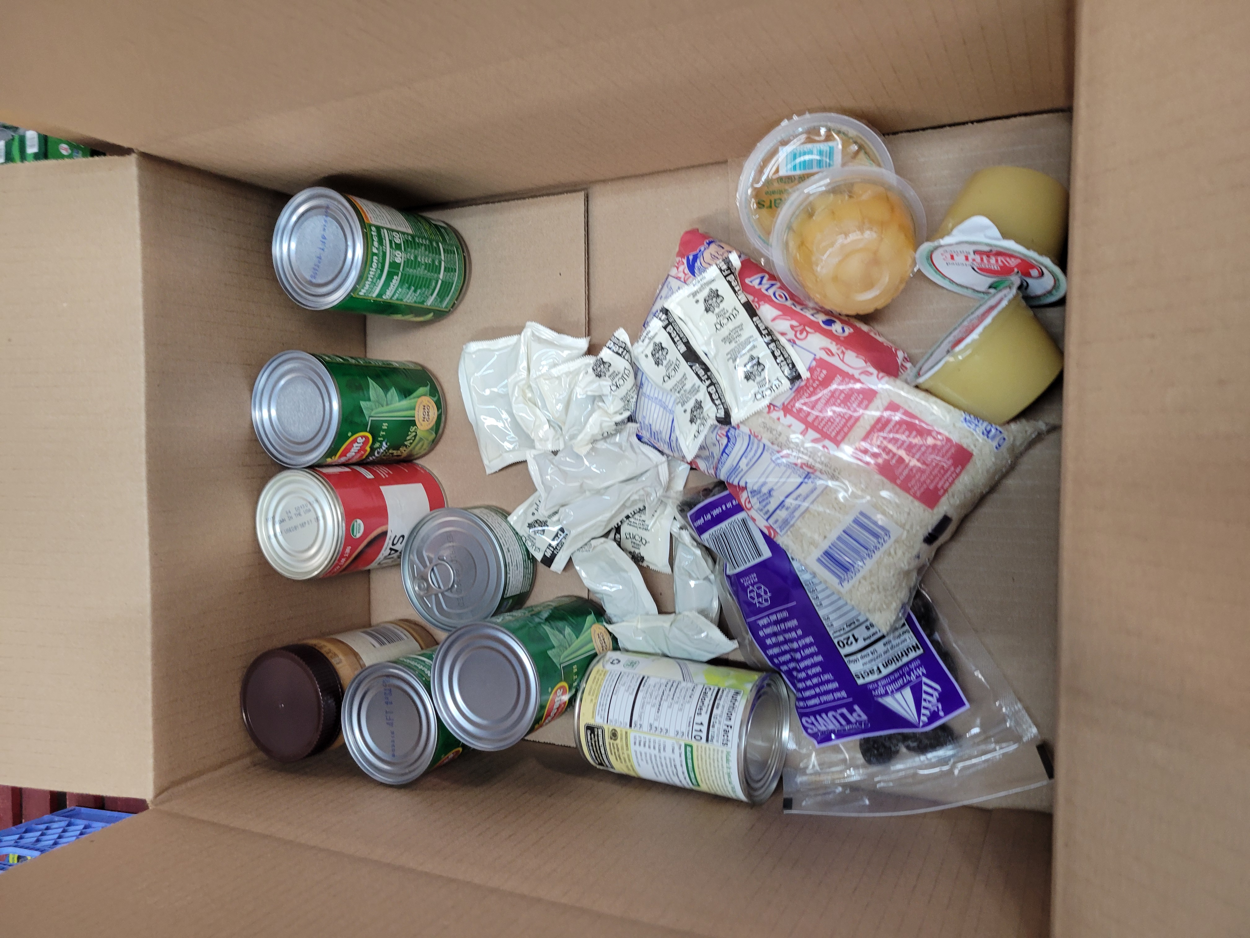 Cardboard box full of dry goods.